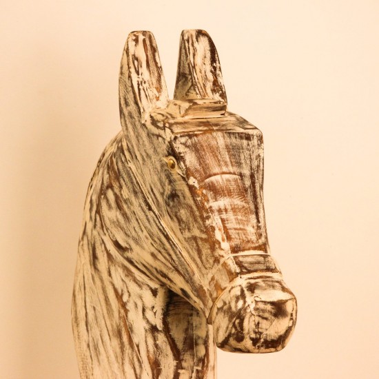 Hand-carved wooden horse head in a distressed whitewash finish, with a flowing textured mane, mounted on a slender black iron stand as a standalone decorative accent.