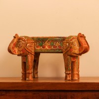 Hand Painted Wooden Elephant Bowl Stand Wooden bowl held up by three carved elephant heads, hand painted in red, yellow, and green with a floral mandala pattern inside the bowl and detailed motifs on the elephants.