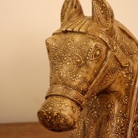 Antique Carved Horse Head Styled on Shelf Antique-finish carved horse head styled on a wooden shelf as a 10 inch tabletop accent.