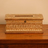 Top view of a wooden tissue box with an oval dispensing cut-out, edged with a white hand-painted floral border and small gold dot accents.