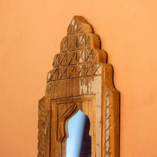 Jharokha Mirror Frame – Natural Wood, Front View Front view of a hand-carved wooden mirror frame in a jharokha arch shape, with a lattice-carved crown and an arched mirror at the centre, hung on an orange wall.