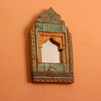 Jharokha Mirror Frame – Green, Styled on Wall Small 13 inch green distressed jharokha mirror frame mounted on an orange wall as a colourful entryway accent.
