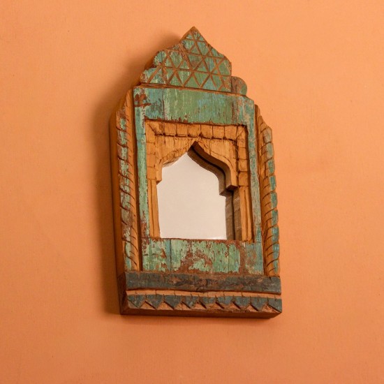 Jharokha Mirror Frame – Green, Styled on Wall Small 13 inch green distressed jharokha mirror frame mounted on an orange wall as a colourful entryway accent.
