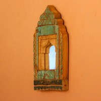 Jharokha Mirror Frame – Green, Styled on Wall Small 13 inch green distressed jharokha mirror frame mounted on an orange wall as a colourful entryway accent.