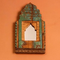 Jharokha Mirror Frame – Rustic Green, Front View Front view of a hand-carved wooden mirror frame in a jharokha arch shape, in weathered green with chipped paint, a lattice-carved crown and an arched mirror at the centre.
