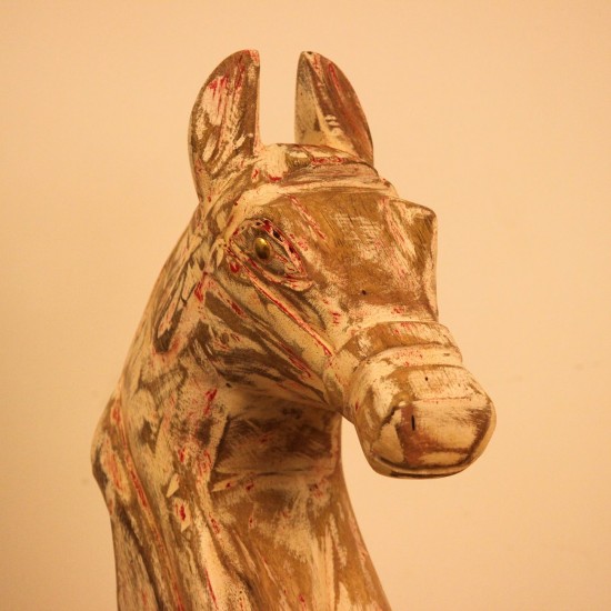 Rustic Pink Horse Head Sculpture Styled on Console Rustic pink-streaked wooden horse head sculpture on a stand, styled on a wooden console as a tabletop accent.