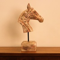 Rustic Pink Horse Head Sculpture Styled on Console Rustic pink-streaked wooden horse head sculpture on a stand, styled on a wooden console as a tabletop accent.