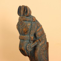 Blue distressed carved wooden horse on stand styled on a wooden table as table décor