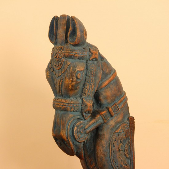 Blue distressed carved wooden horse on stand styled on a wooden table as table décor