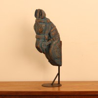 Blue distressed carved wooden horse on stand styled on a wooden table as table décor