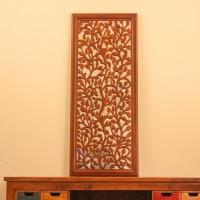 Sagwan wood leaf engraved wall mural hung on a warm wall above a console