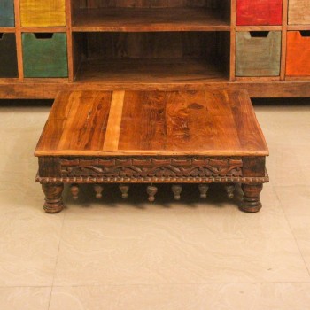 Large solid wood bajot styled on the floor in front of a wooden sideboard with colourful drawers