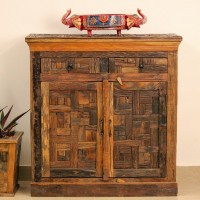 Reclaimed Sleeper Wood Cabinet with Drawers – Styled in Room Reclaimed sleeper wood cabinet styled in a living room beside a plant, with a painted décor piece on top