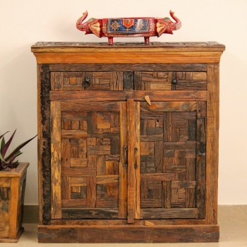 Reclaimed Sleeper Wood Cabinet with Drawers – Styled in Room Reclaimed sleeper wood cabinet styled in a living room beside a plant, with a painted décor piece on top