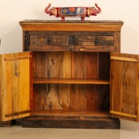 Reclaimed Sleeper Wood Cabinet with Drawers – Styled in Room Reclaimed sleeper wood cabinet styled in a living room beside a plant, with a painted décor piece on top