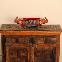 Reclaimed Sleeper Wood Cabinet with Drawers – Styled in Room Reclaimed sleeper wood cabinet styled in a living room beside a plant, with a painted décor piece on top