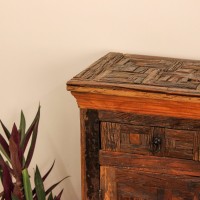 Reclaimed Sleeper Wood Cabinet with Drawers – Styled in Room Reclaimed sleeper wood cabinet styled in a living room beside a plant, with a painted décor piece on top