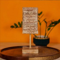Small distressed white hand carved wooden block mounted on iron stand for vintage tabletop decor