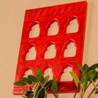 Rich red handcrafted wall decor with nine arch cutouts, designed to create a bold and traditional statement.