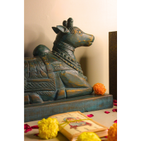 Distressed Blue Nandi Wooden Sculpture – Handcrafted Home Décor Full setup of distressed blue Nandi sculpture with candles and Ganesh idol – handcrafted Indian handicraft for home temple and gifting.