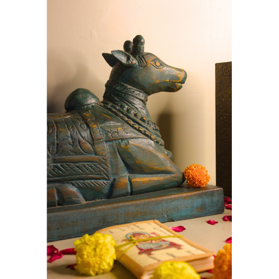 Distressed Blue Nandi Wooden Sculpture – Handcrafted Home Décor Full setup of distressed blue Nandi sculpture with candles and Ganesh idol – handcrafted Indian handicraft for home temple and gifting.