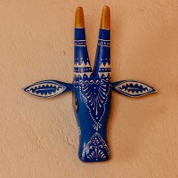 White base cow face wall decor with blue handpainted detailing in traditional Indian folk art style.