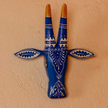 White base cow face wall decor with blue handpainted detailing in traditional Indian folk art style.