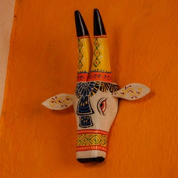 White and blue handpainted cow face wall decor featuring traditional Indian folk art patterns and detailing.