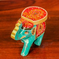 Small handpainted teal green elephant figurine with vibrant red and yellow detailing, designed in traditional Indian folk art style.