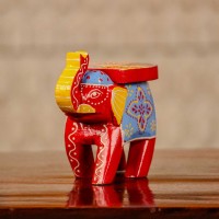 Small handpainted red elephant figurine with vibrant traditional patterns, crafted in Indian folk art style.