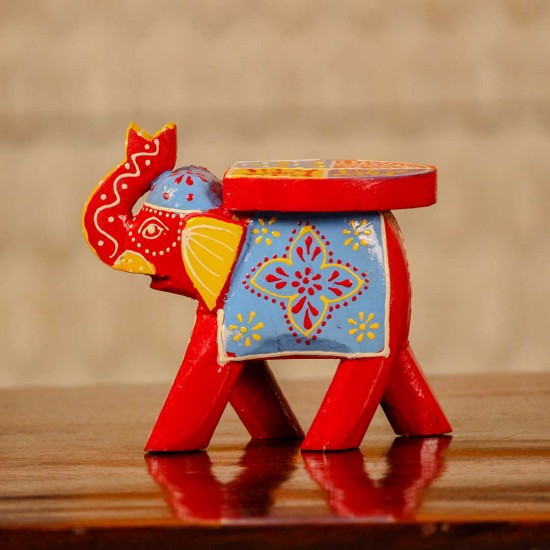 Small handpainted red elephant figurine with vibrant traditional patterns, crafted in Indian folk art style.