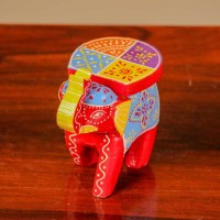 Small handpainted red elephant figurine with vibrant traditional patterns, crafted in Indian folk art style.