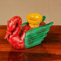 Decorative wooden duck in red and green finish with handpainted patterns and a small holder on top for table styling.