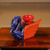 Decorative wooden duck in blue and orange finish with intricate handpainted patterns and a utility holder on top.