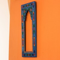 Hand Painted Floral Arch Frame – Blue, Front View Front view of a tall wooden arch-shaped frame hand painted in bright blue, with floral borders in pink, red, yellow and green and an open arched centre.