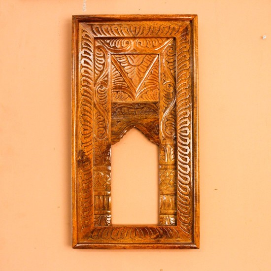 Hand Carved Wooden Arch Frame – Front View Front view of a tall rectangular wooden frame hand carved all over in an antique natural finish, with a leaf-patterned border and an arched opening below a carved panel.