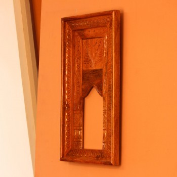 Hand Carved Wooden Arch Frame – Front View Front view of a tall rectangular wooden frame hand carved all over in an antique natural finish, with a leaf-patterned border and an arched opening below a carved panel.