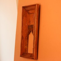 Hand Carved Wooden Arch Frame – Front View Front view of a tall rectangular wooden frame hand carved all over in an antique natural finish, with a leaf-patterned border and an arched opening below a carved panel.