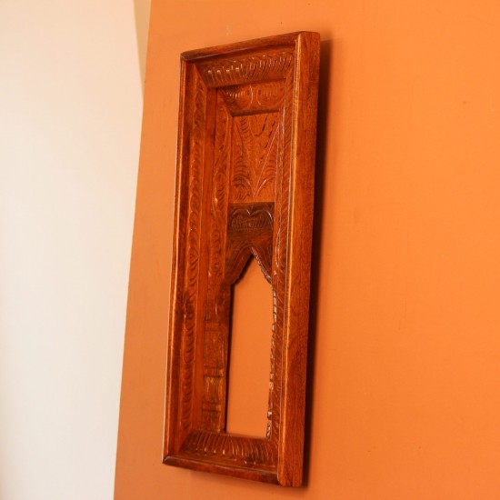 Hand Carved Wooden Arch Frame – Front View Front view of a tall rectangular wooden frame hand carved all over in an antique natural finish, with a leaf-patterned border and an arched opening below a carved panel.