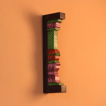 Extreme close-up of the carved petal-shaped bands in pink, red and purple, with ridged layers and painted green edging.