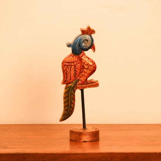 Handcrafted Bird Table Decor on Iron Stand Artistic wooden bird figurine mounted on an iron stand with handcrafted detailing and vibrant ethnic-inspired colors.