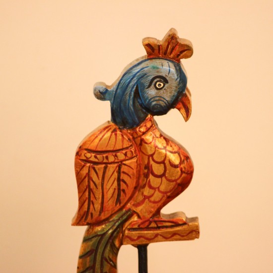 Handcrafted Bird Table Decor on Iron Stand Artistic wooden bird figurine mounted on an iron stand with handcrafted detailing and vibrant ethnic-inspired colors.