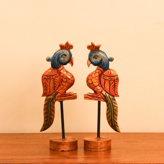 Handcrafted Bird Table Decor on Iron Stand Artistic wooden bird figurine mounted on an iron stand with handcrafted detailing and vibrant ethnic-inspired colors.