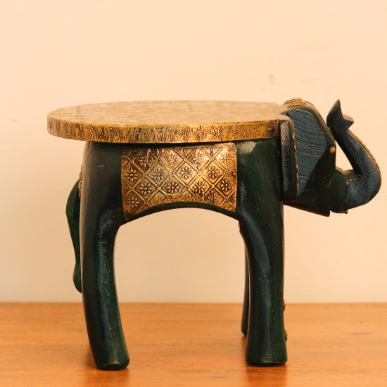 Elephant Stool – Green with Embossed Brass, Side View Side view of the elephant stool, showing the raised trunk, the brass-embossed seat and the brass side panel set between the dark green legs.