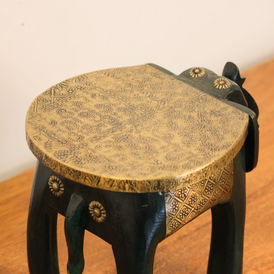 Elephant Stool – Green with Embossed Brass, Side View Side view of the elephant stool, showing the raised trunk, the brass-embossed seat and the brass side panel set between the dark green legs.