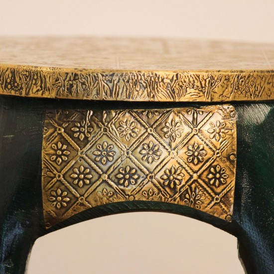 Elephant Stool – Green with Embossed Brass, Side View Side view of the elephant stool, showing the raised trunk, the brass-embossed seat and the brass side panel set between the dark green legs.