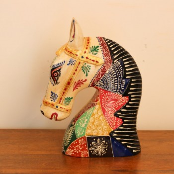 Hand Painted Patchwork Horse Head Decor Styled on Table Hand-painted patchwork wooden horse head with a cream face placed on a wooden table as a colourful tabletop accent.
