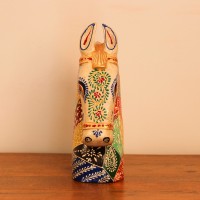 Hand Painted Patchwork Horse Head Decor Styled on Table Hand-painted patchwork wooden horse head with a cream face placed on a wooden table as a colourful tabletop accent.