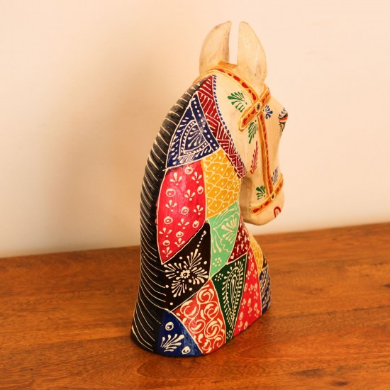 Hand Painted Patchwork Horse Head Decor Styled on Table Hand-painted patchwork wooden horse head with a cream face placed on a wooden table as a colourful tabletop accent.