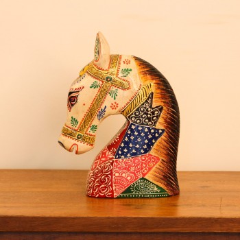 Hand Painted Folk Motif Horse Head Decor Styled on Table Hand-painted folk motif wooden horse head with a cream face placed on a wooden table as a colourful tabletop accent.